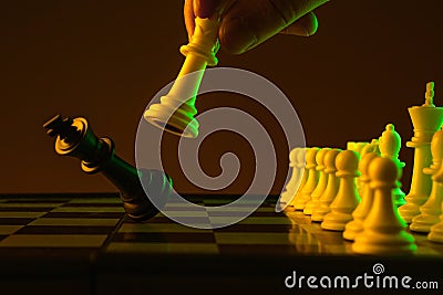 Close-up hand makes a move, check and checkmate, chess, chessboard, game, confrontation. career, promotion, startup crisis Stock Photo