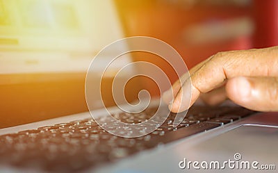 close up hand of male typing on laptop keyboard in office, busin Stock Photo