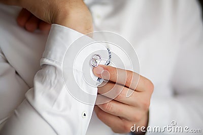 Close up of a hand man how wears white shirt and cufflink Stock Photo