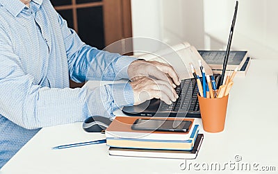 Close-up of hand man using a mouse and typing on laptop on white table, business concept Stock Photo