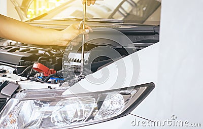 Closeup of hand mechanic engineer fixing car battery at garage,concept car maintenance Stock Photo