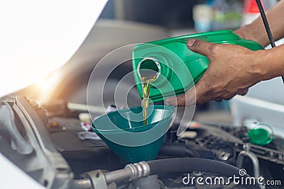 Close up hand mechanic repairing change the Oil. Car mechanic po Stock Photo