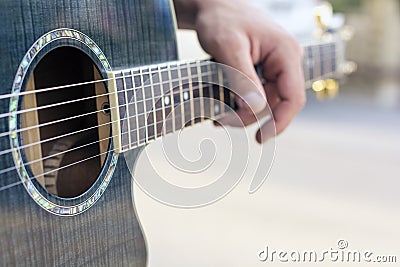 Close up hand musician playing acoustic guitar Stock Photo