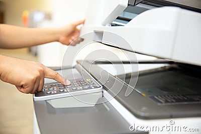 Close up hand office man press copy button on panel to using the copier or photocopier machine for scanning Stock Photo