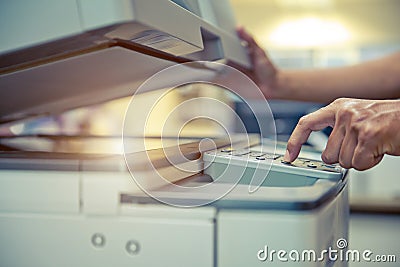 Close up hand office man press copy button on panel to using the copier or photocopier machine for scanning Stock Photo