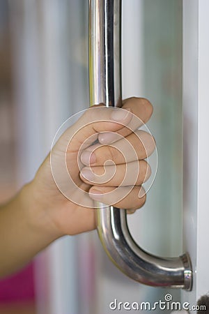 Close-up of hand open Aluminum glass door or Hand holding handle Stock Photo