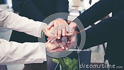 Close up hand Partners Team work joining hands to success together. Business Team stack of hands for star up project in cafe Stock Photo