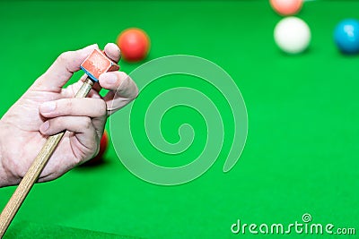 Close up hand player snooker using chalk rubbing a cue Stock Photo