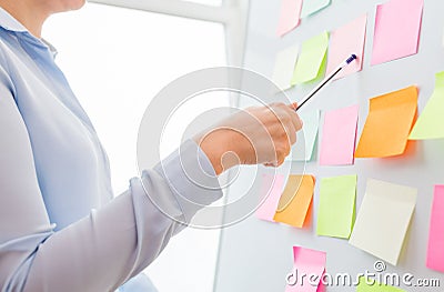 Close up of hand pointing to sticker on flip chart Stock Photo