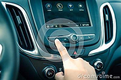 Male hand press the Previous button on modern car dashboard Stock Photo