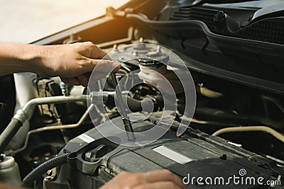 Close up of hand professional mechanic repairing a car in auto repair shop Stock Photo