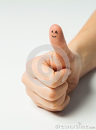 Close up of hand showing thumb with smiley face Stock Photo