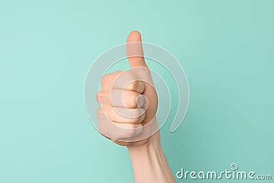 Close up of hand showing thumbs up sign Stock Photo