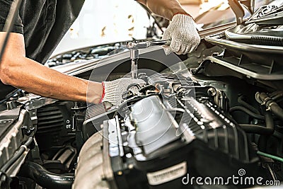 Close-up hand technician auto mechanic using the wrench to repairing change spare part car Stock Photo