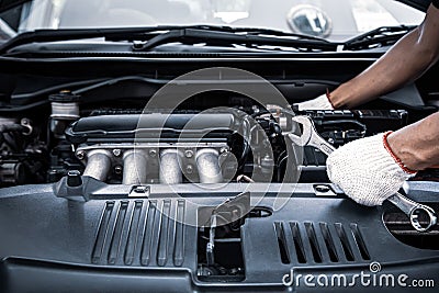 Close-up hand technician auto mechanic using the wrench to repairing change spare part car Stock Photo