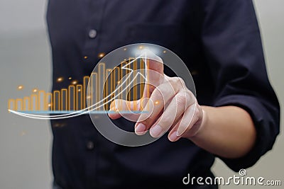 Close up of hand touching on virtual glowing business chart hologram on blurred background. Market, analytics and technolo concept Stock Photo