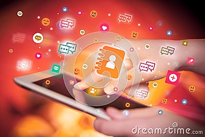 Close-up of a hand using tablet with social media icons Stock Photo