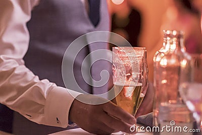 Close up of hand of waiter serving a bottle Stock Photo