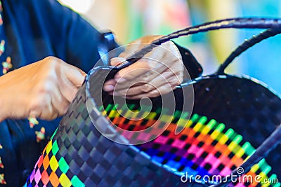 Close up hand of weaver during weaving basket made from plastic Stock Photo