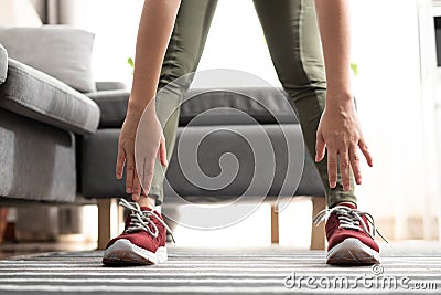 Close up hand woman touching her toes stretches. Standing forward bend yoga pose stretch at home Stock Photo