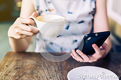 Close up hand woman using smartphone in coffee shop Stock Photo