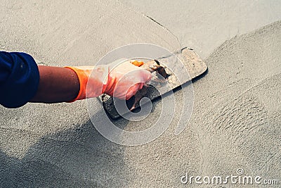 close up hand worker leveling concrete pavement for mix cement a Stock Photo