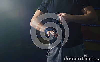 Close-up of the hand of a young boxer who winds boxing bandages Stock Photo