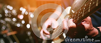 Close up hand young man playing electric guitar at recording studio rehearsal base. rock music band Stock Photo