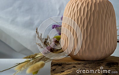 Close-up of Handmade Ceramic Vases and Dried flowers on wooden logs Stock Photo