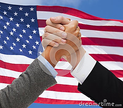 Close up of hands armwrestling over american flag Stock Photo