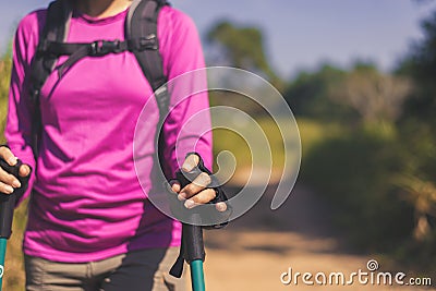 Close up of hands backpacking Asian woman holding trekking pole,Camping hiking concept Stock Photo