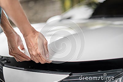 Close up of hands being open the car hood or bonnet for maintenance checking engine before a trip or journey, Car check condition Stock Photo