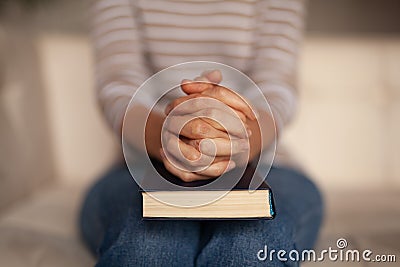 Close up, hands on the bible. A believing Christian prays to God. Religious traditions Stock Photo