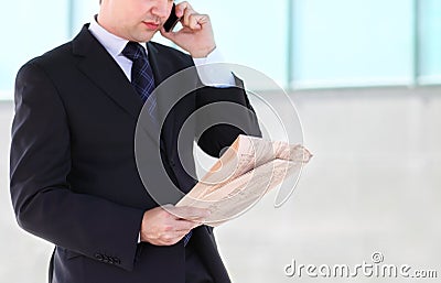 Close up of the hands of the businessman with a newspaper. Outdo Stock Photo