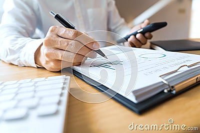 Close-up of hands Businessman reading and writing with pen signing contract over document for Completing Application Form at work Stock Photo