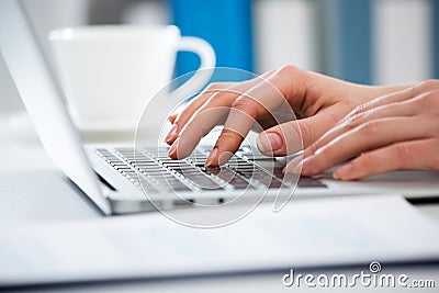 Close-up of hands of businesswoman typing on a laptop Stock Photo