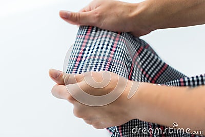 Close up of hands with checkered clothing item Stock Photo