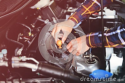 Close up hands checking lube oil level of car engine from deep-stick for service and maintenance concept vintage tone Stock Photo