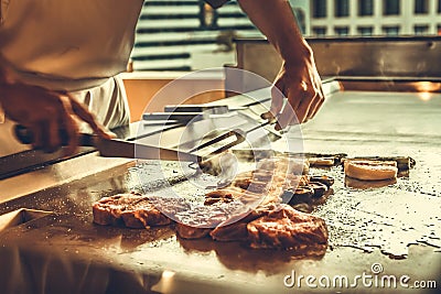Close up hands chef cooking beef steak and vegetable on hot pan Stock Photo