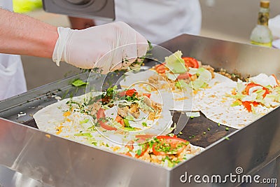 Close-up of hands of cook. Easy to prepare, but tasty, healthy and hearty. Concept of Mexican food. Party food, fresh Stock Photo