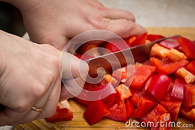 Close up of hands cutting vegetables with a knife Stock Photo