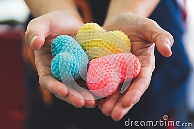 Close up hands giving colorful yarn heart handmade. Valentine da Stock Photo