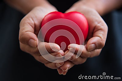 Close up hands giving red heart as heart donor. Valentine day of love concept. Medical ventilator and heart donator charity. Sign Stock Photo