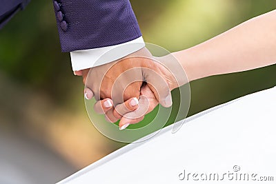 Close-up of the hands of the groom and the bride walking Stock Photo