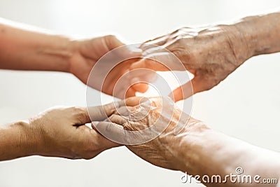 Close up hands of helping hands elderly home care. Mother and daughter Stock Photo