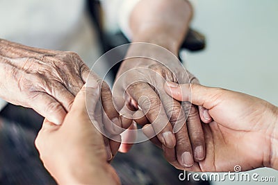 Close up hands of helping hands for elderly home care. Stock Photo