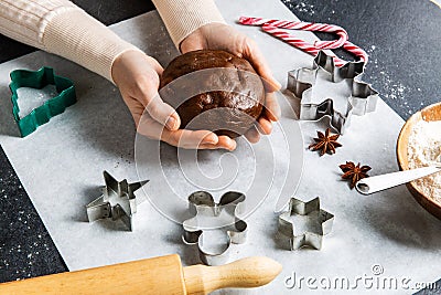 close up of hands holding gingerbread dough Stock Photo