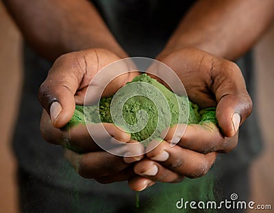 Close-up of hands holding green powder Stock Photo