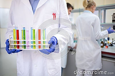 Close up of hands holding tests tubes Stock Photo