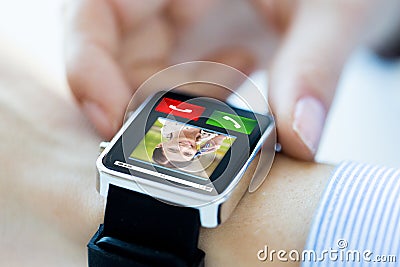 Close up of hands with incoming call on smartwatch Stock Photo